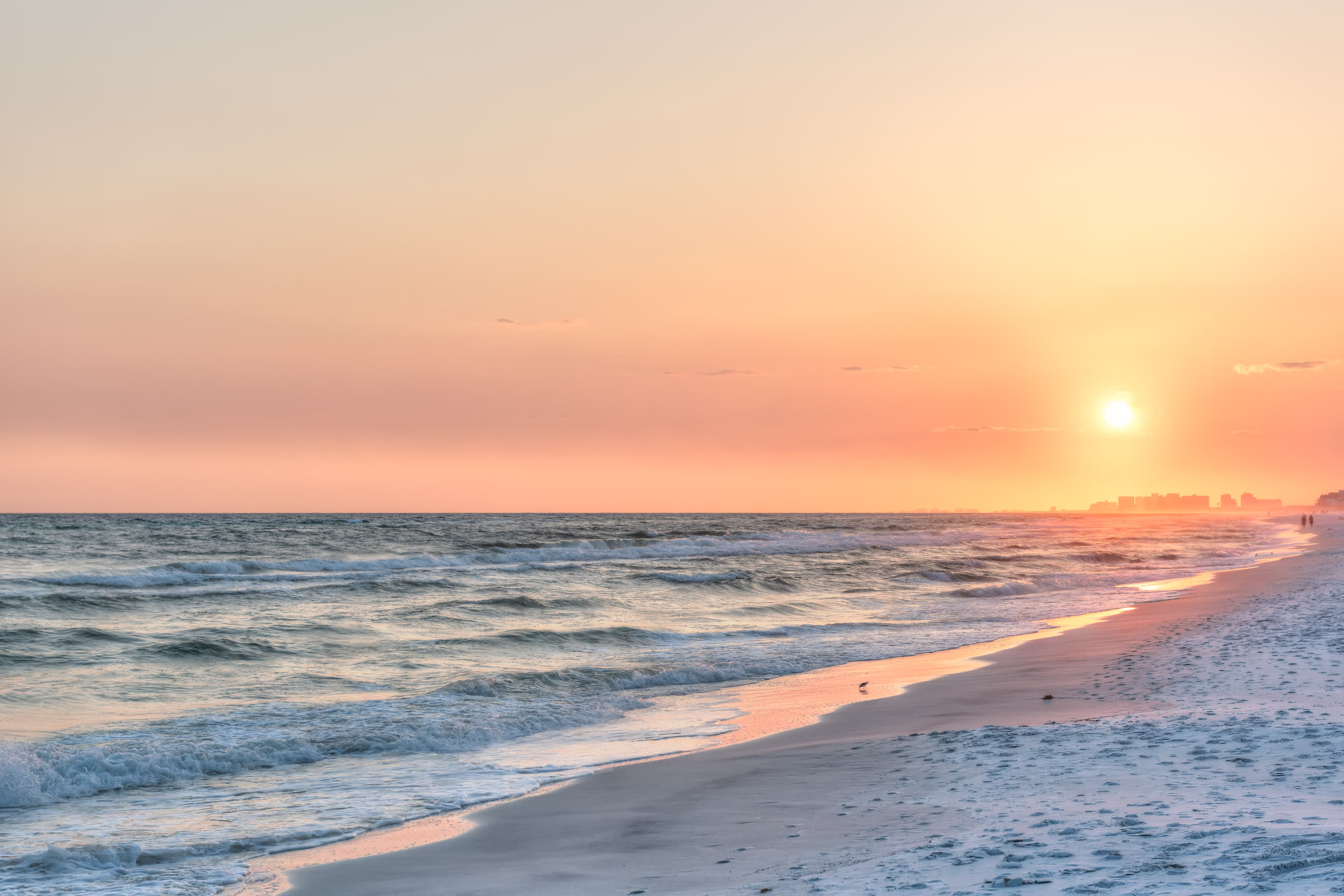 Sunset over the empty white sand and low surf at Mexico Beach